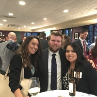 A man and two women smiling at the camera